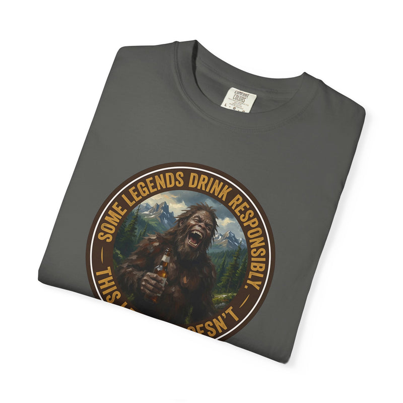 Dark gray graphic t-shirt with circular Sasquatch-themed logo on the front, angled