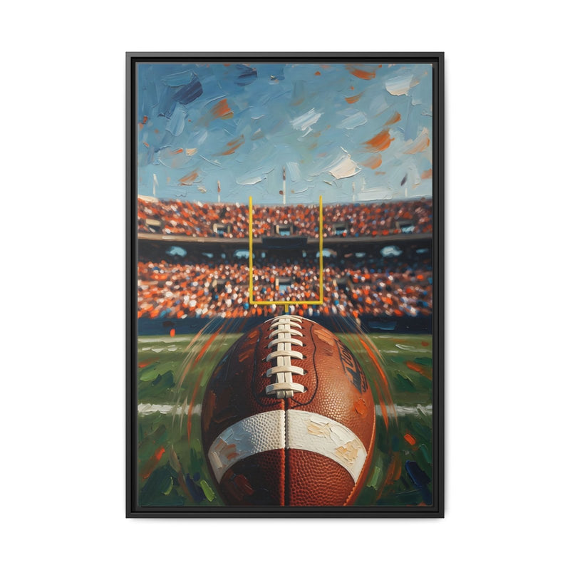 Black-framed canvas wall art showing a football centered with goal posts and crowd lights.