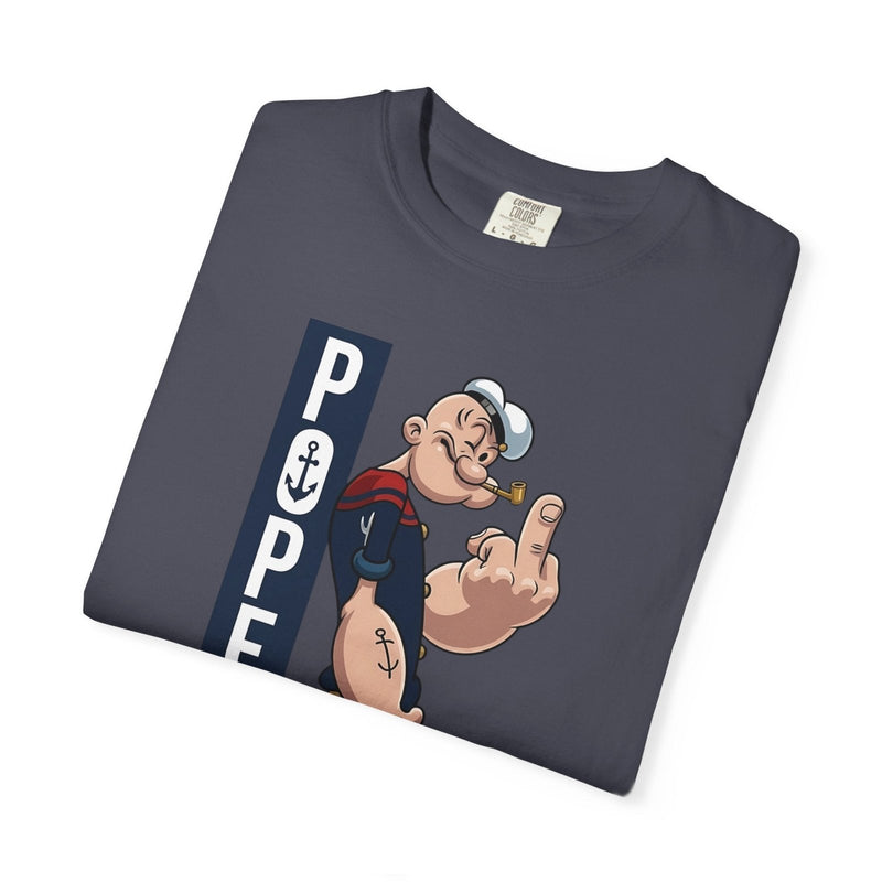 Slate blue folded graphic cartoon T-shirt with vertical sailor-themed print at center