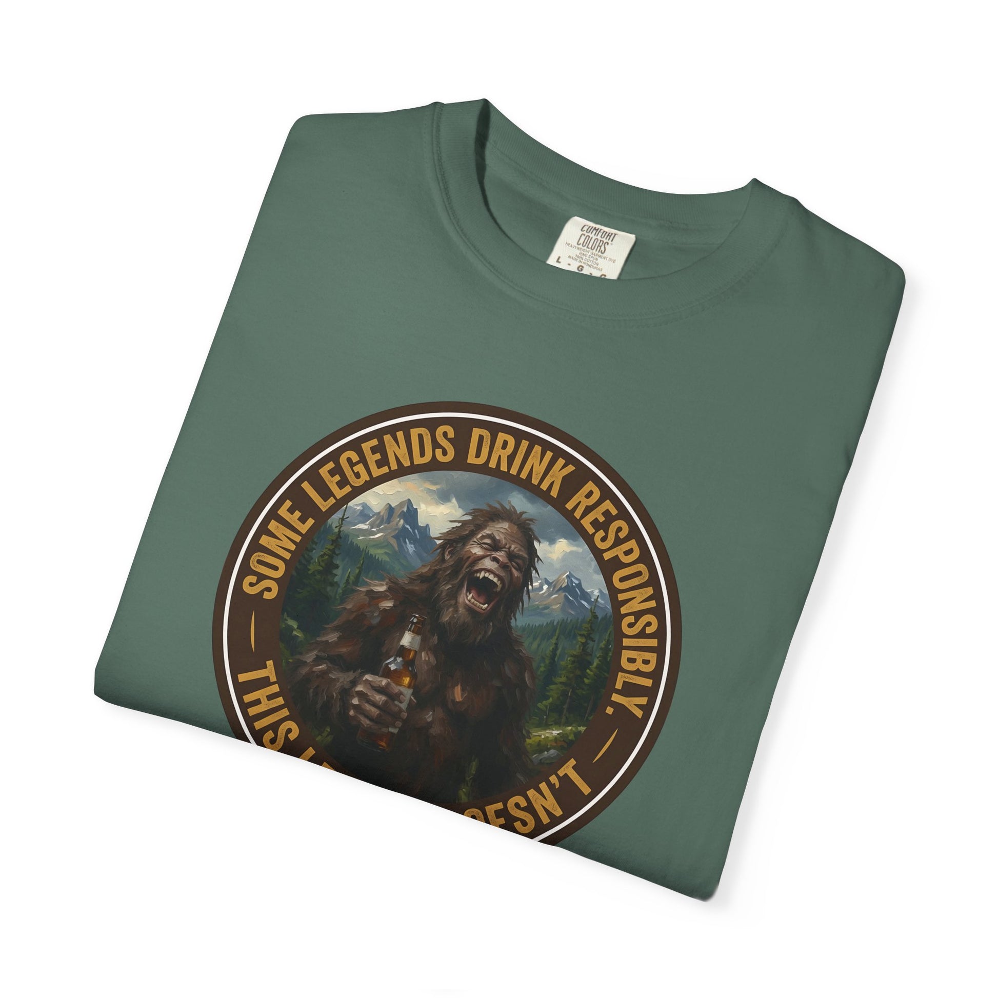 Green graphic T-shirt with circular Sasquatch-style face emblem on chest