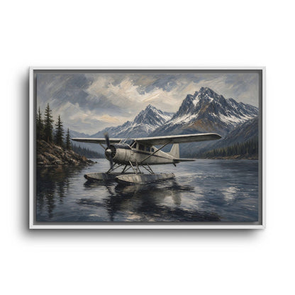 Black-framed canvas print of a seaplane on still lake waters beside tall mountain peaks