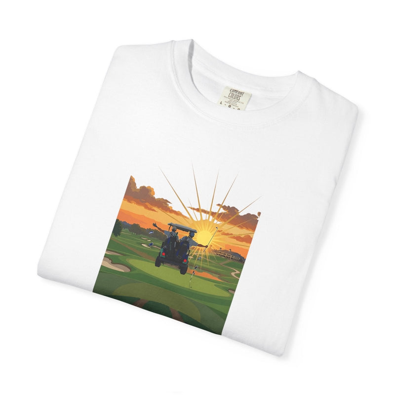 White golf T-shirt laid flat, featuring a front graphic of a golf cart at sunset and “THE 19TH HOLE”.