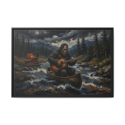 Framed canvas wall art, black frame with Bigfoot in canoe playing guitar on a forest river