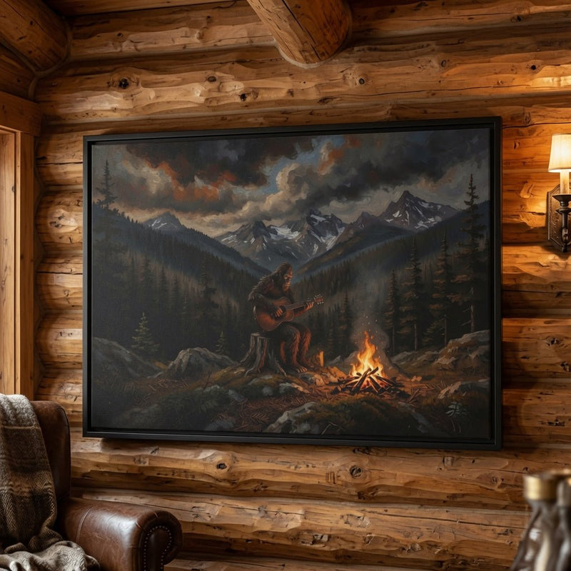 Black framed canvas print of Bigfoot guitarist by campfire in a mountain valley