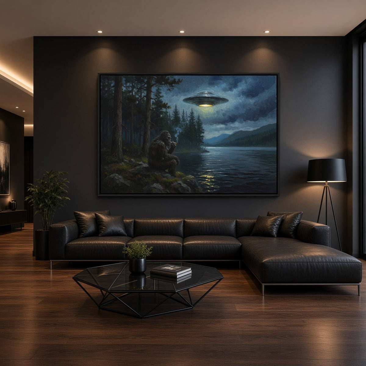 Black-framed Bigfoot and UFO canvas print on a gray wall above a dark sectional.