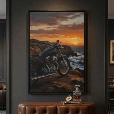 Framed canvas print with black frame featuring a motorcycle at sunset on a rocky coastline