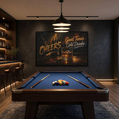 Black-framed whiskey bar canvas with a glass of whiskey and Cheers lettering, displayed above a pool table