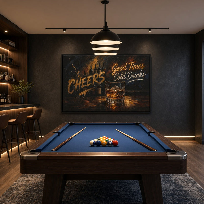 Black-framed whiskey bar canvas with a glass of whiskey and Cheers lettering, displayed above a pool table