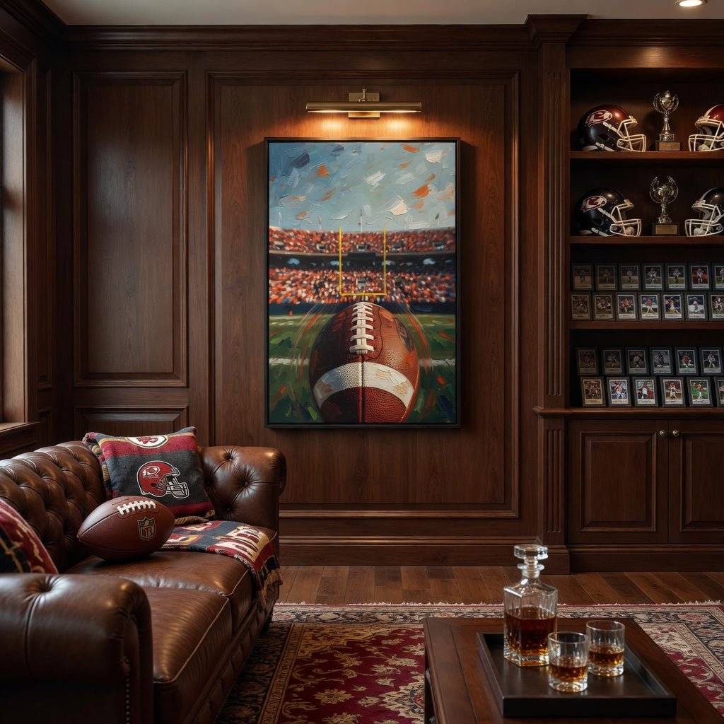 Framed football stadium canvas art with football centerpiece in dark frame.