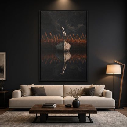 Black-framed canvas wall art with a heron holding an open book in tall grass