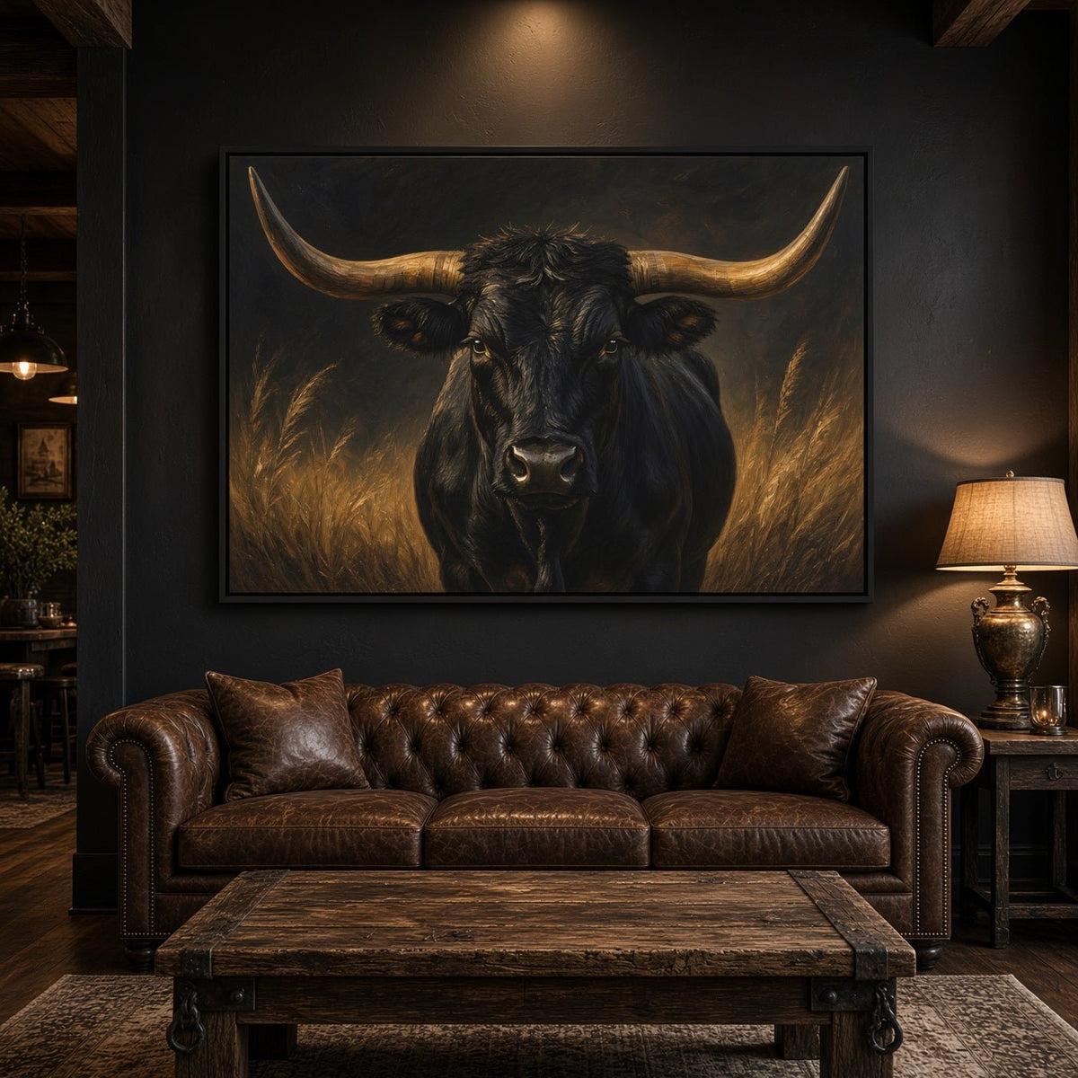 Framed canvas print of a black longhorn bull above a leather sofa