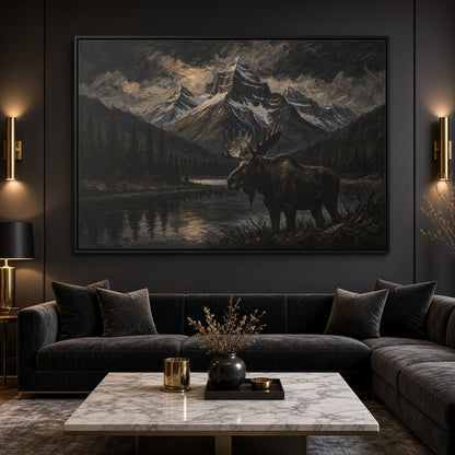 Framed moose and mountain lake canvas wall art above a dark sectional sofa