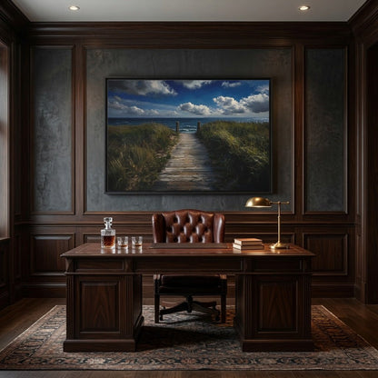 Black framed seascape canvas with sandy path and grasses on dark wall